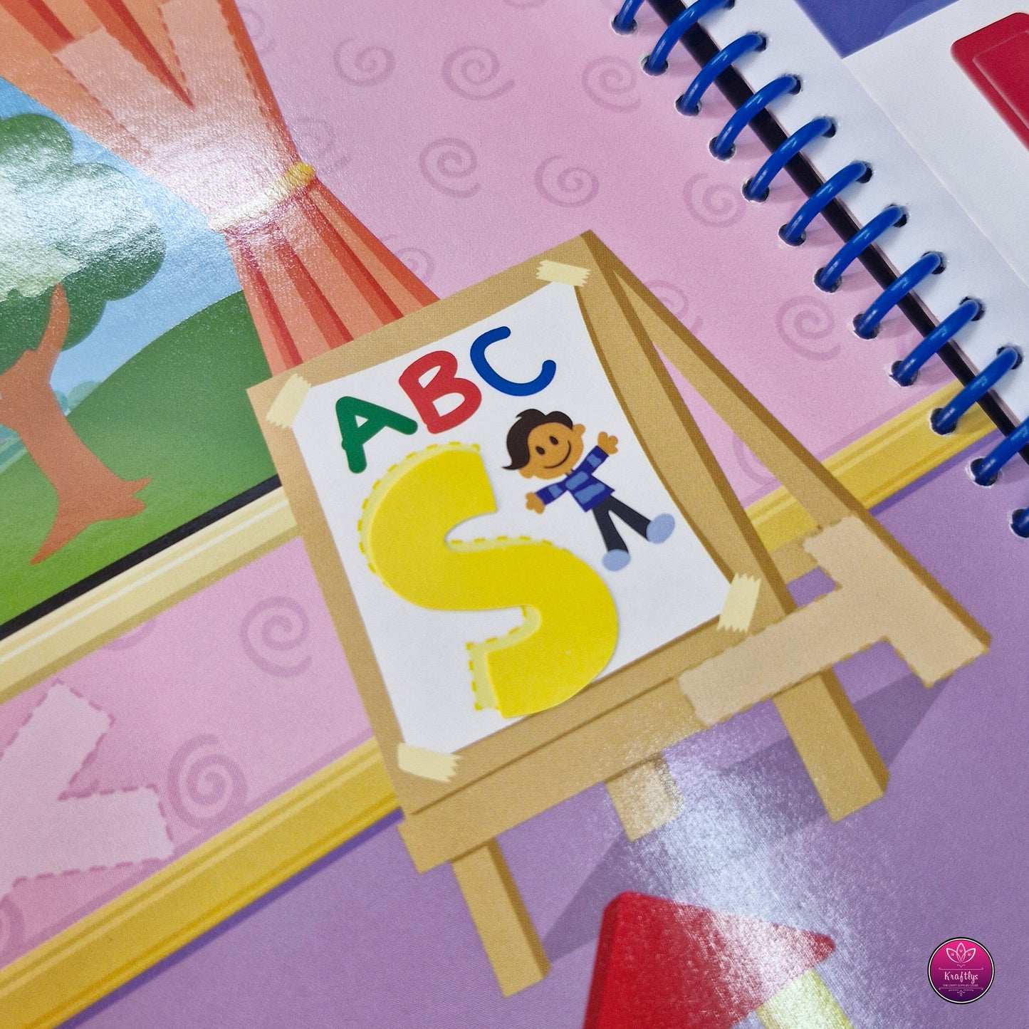 Children's book with an easel and 'ABC' poster on a colorful background
