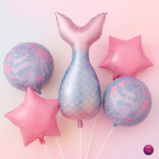 Set of mermaid-themed balloons including a tail, star, and round balloons with 'Happy Birthday' text on a pink background.